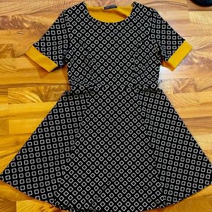 Cute black flare dress with yellow lining and white diamond print. size 10-12
